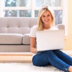 happy young woman using her laptop